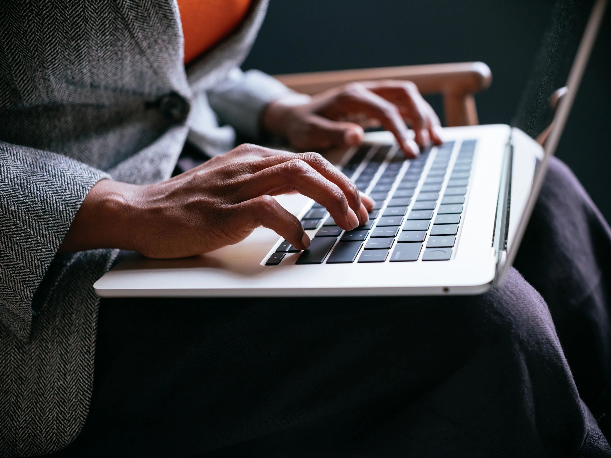 Person typing a product review on a laptop